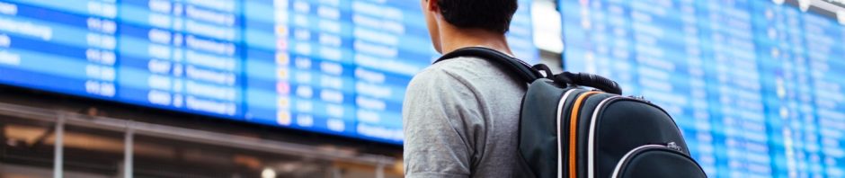 Young man checks flights at the airport